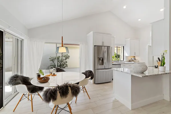 a kitchen with a table and chairs in it