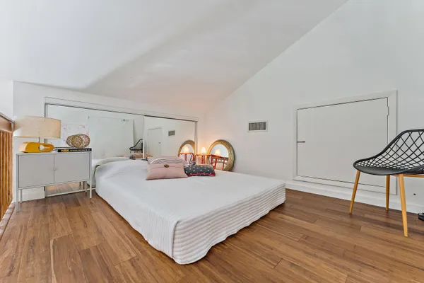 a bedroom with a bed and a dresser