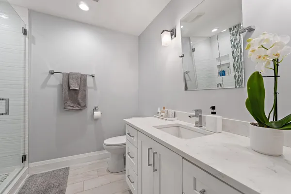 a bathroom with a sink a toilet and mirror