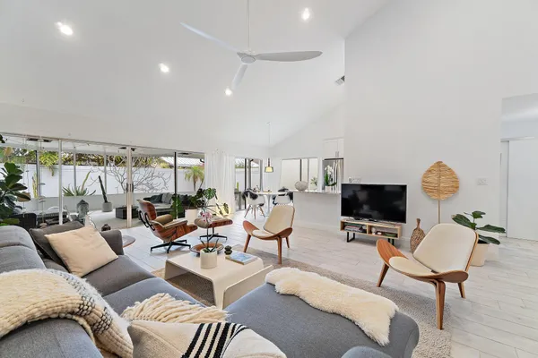 a living room with furniture a flat screen tv and a fireplace