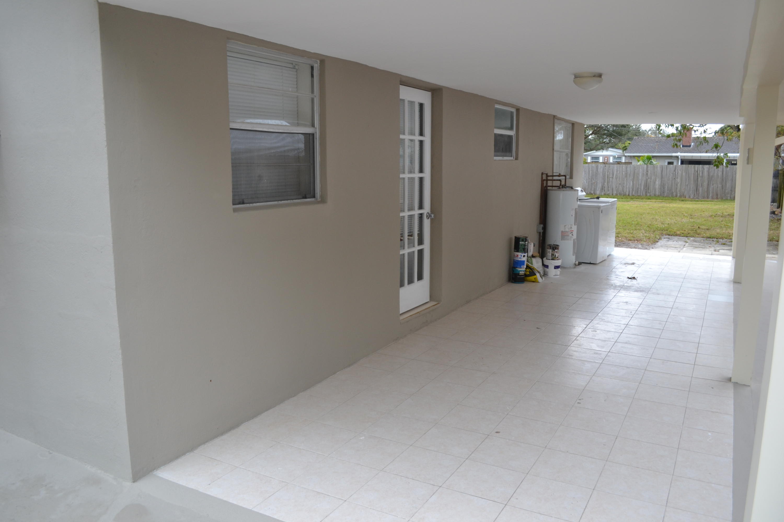 705 North Loxahatchee Drive Jupiter, FL 33458 - Photo 4 of 25 a view of a hallway with furniture and a refrigerator