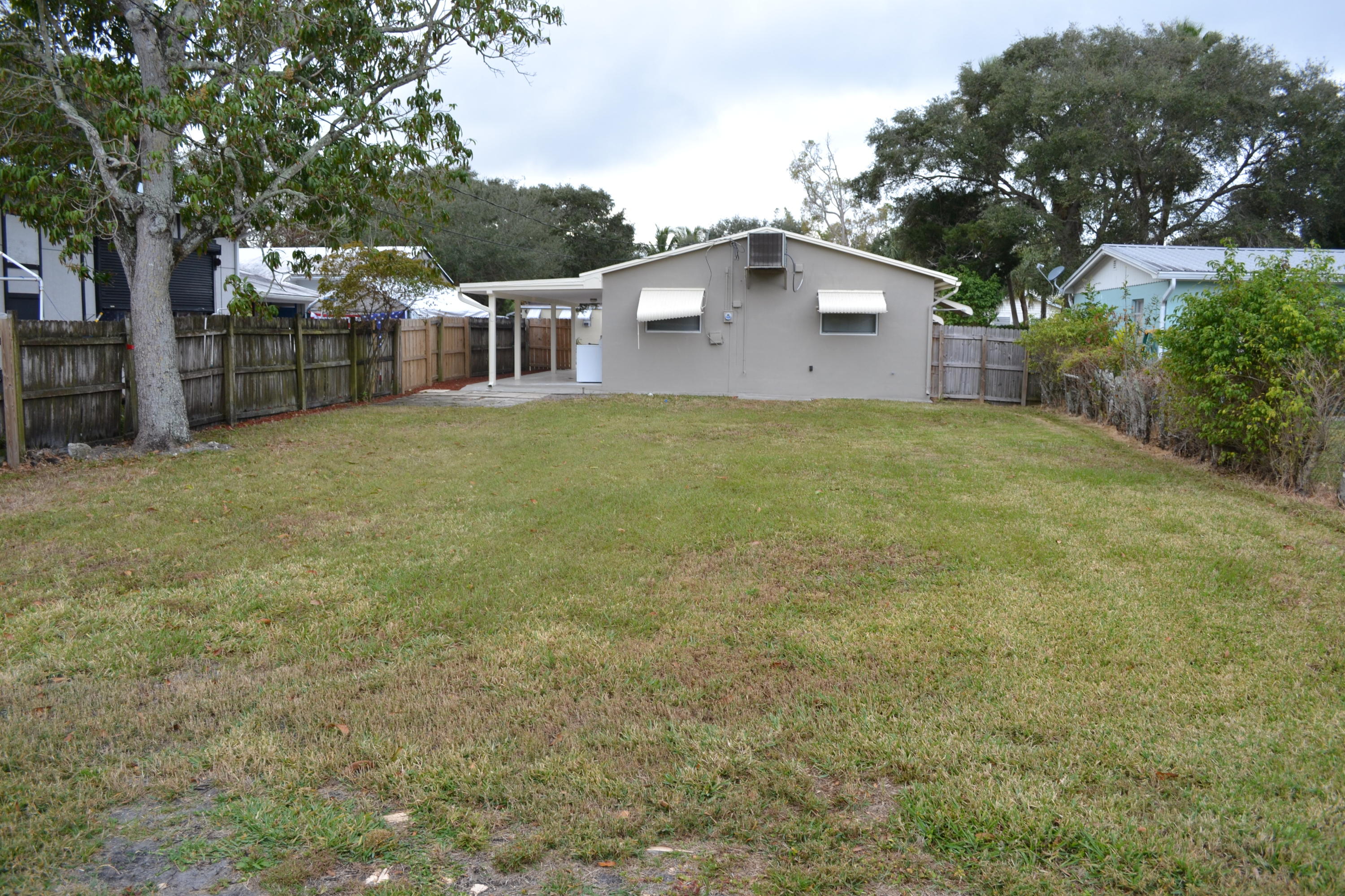 705 North Loxahatchee Drive Jupiter, FL 33458 - Photo 5 of 25 a front view of a house with a garden
