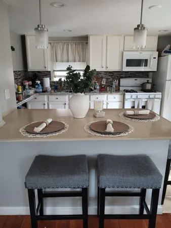 a kitchen with a dining table and chairs