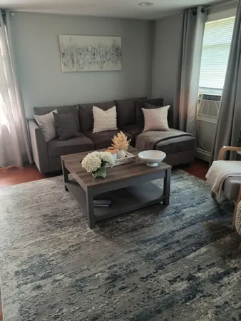 a living room with furniture and a rug