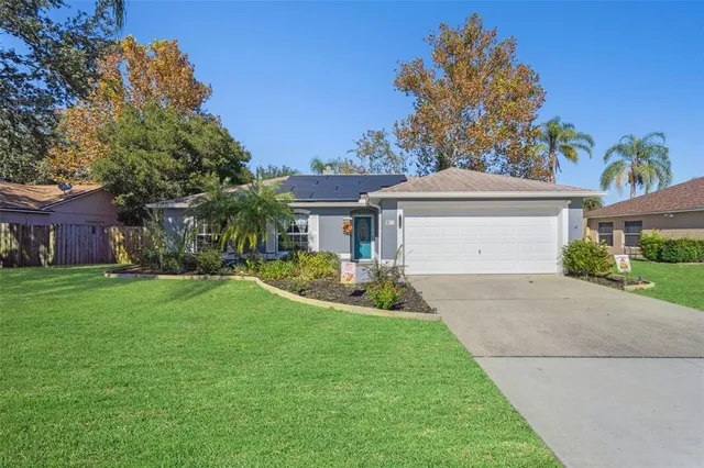 a front view of a house with a garden and yard