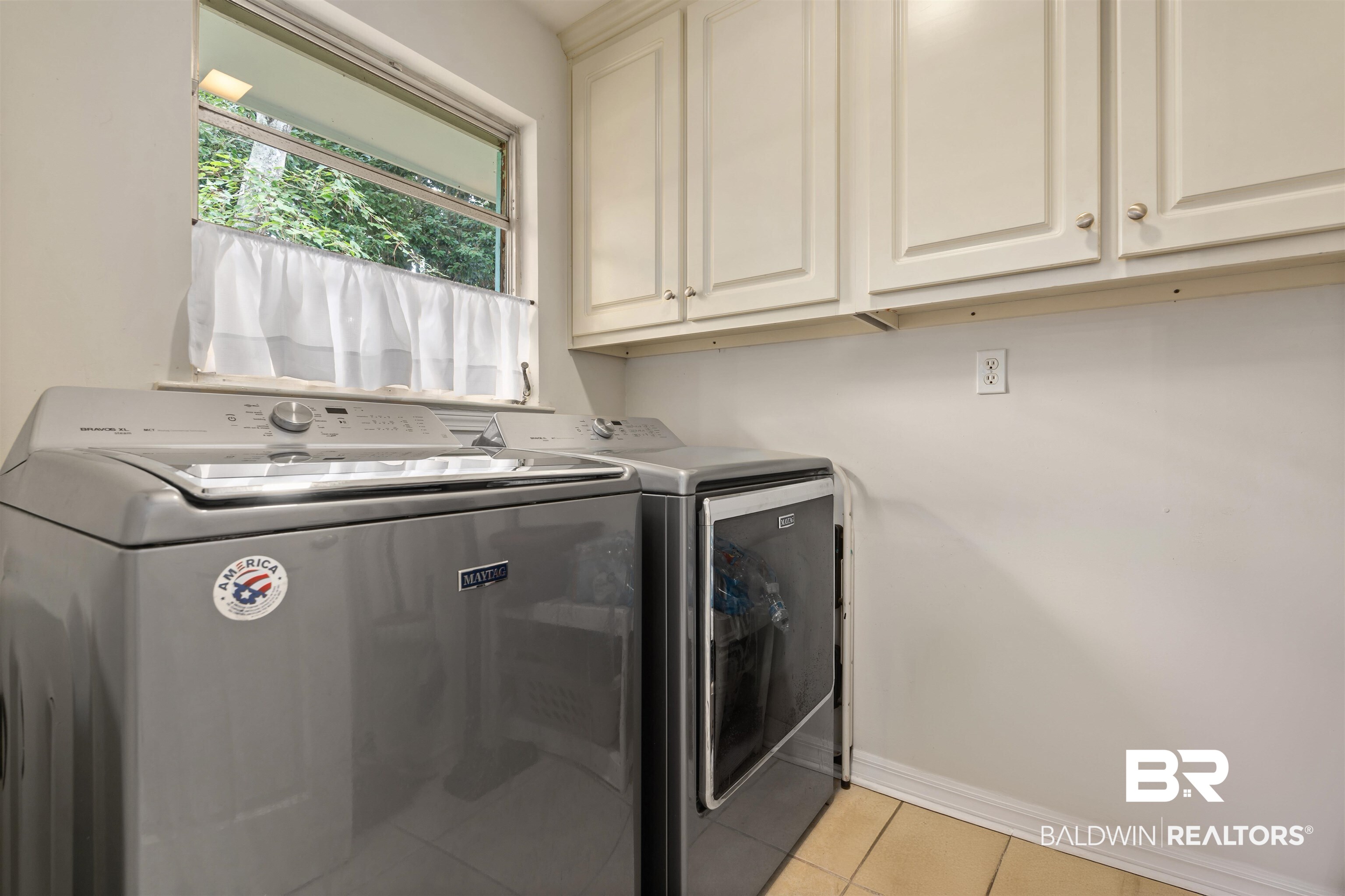 4051 East Canal Circle Mobile, AL 36619 - Photo 26 of 32 Clothes washing area featuring cabinets, light tile patterned floors, and independent washer and dryer