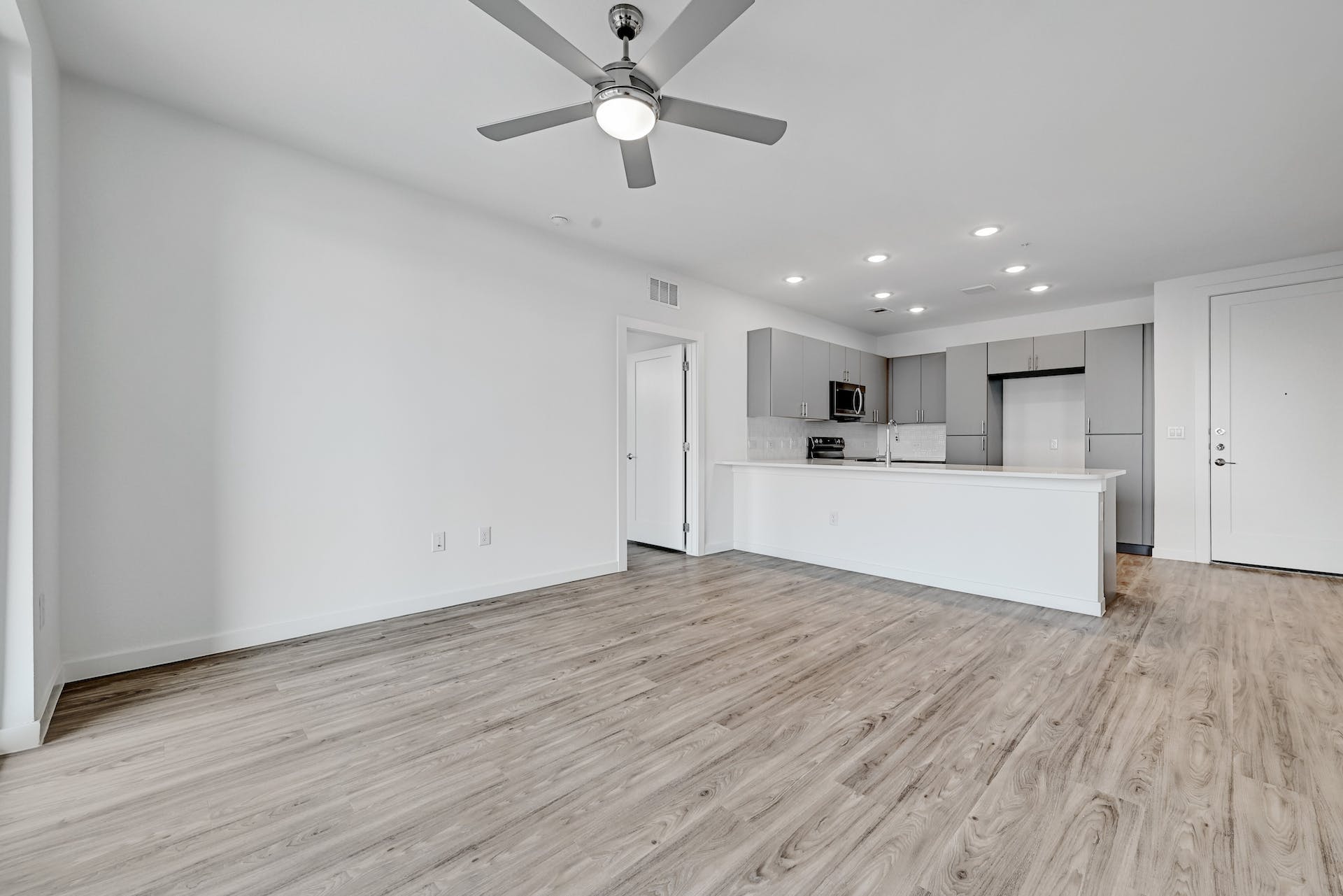 4801 Springdale Road, Unit 1301 Austin, TX 78723 - Photo 11 of 39 An open concept living area features resilient vinyl plank flooring and an integrated modern kitchen.