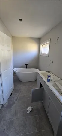 a room with a large window and a rug