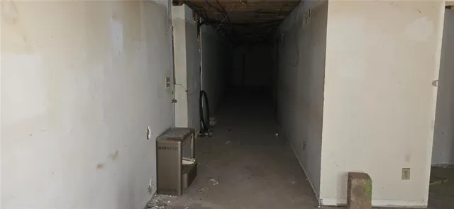 a view of a hallway with wooden floor and a glass door