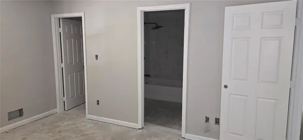 an empty room with closet area