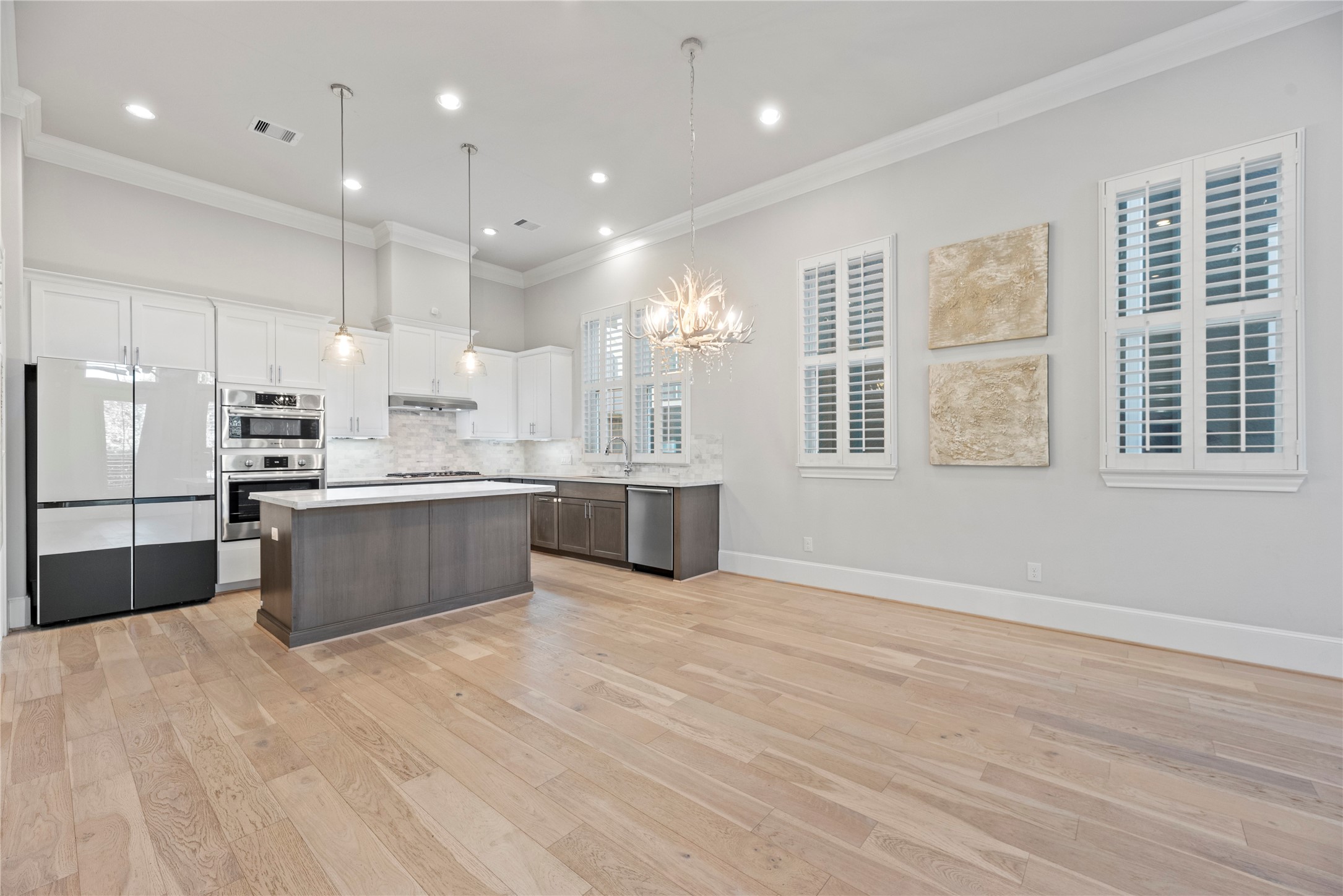 5306 South Capitol Street Houston, TX 77023 - Photo 5 of 28 a large kitchen with stainless steel appliances kitchen island a large counter top and a wooden floors