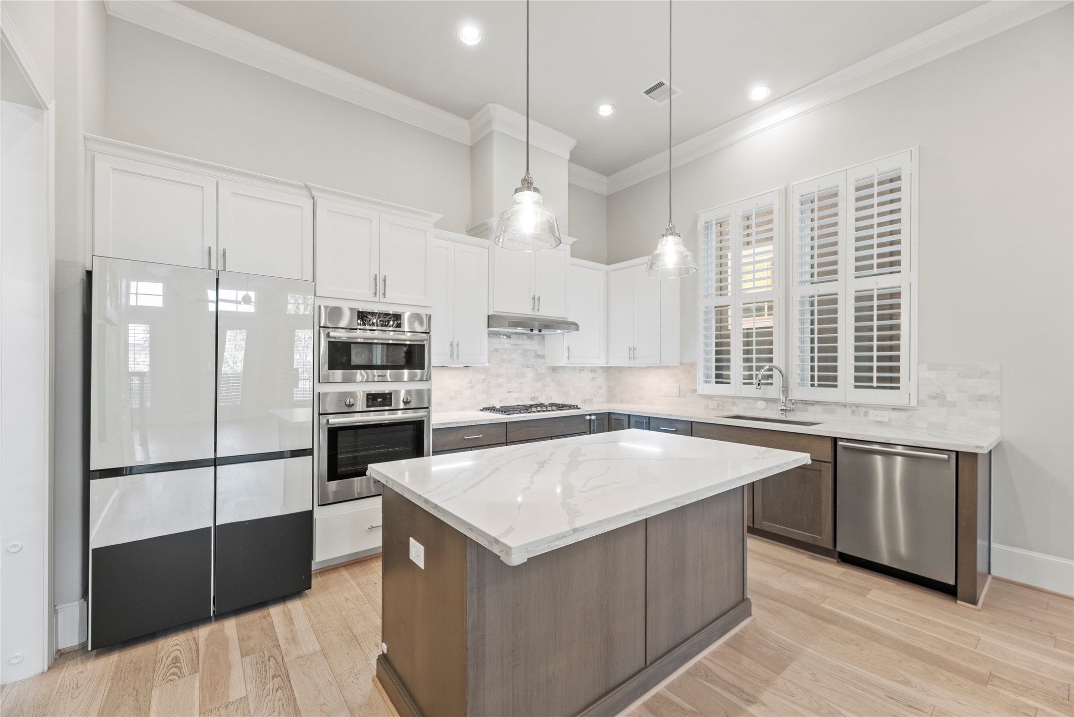 5306 South Capitol Street Houston, TX 77023 - Photo 6 of 28 a kitchen with a refrigerator a sink and wooden floor