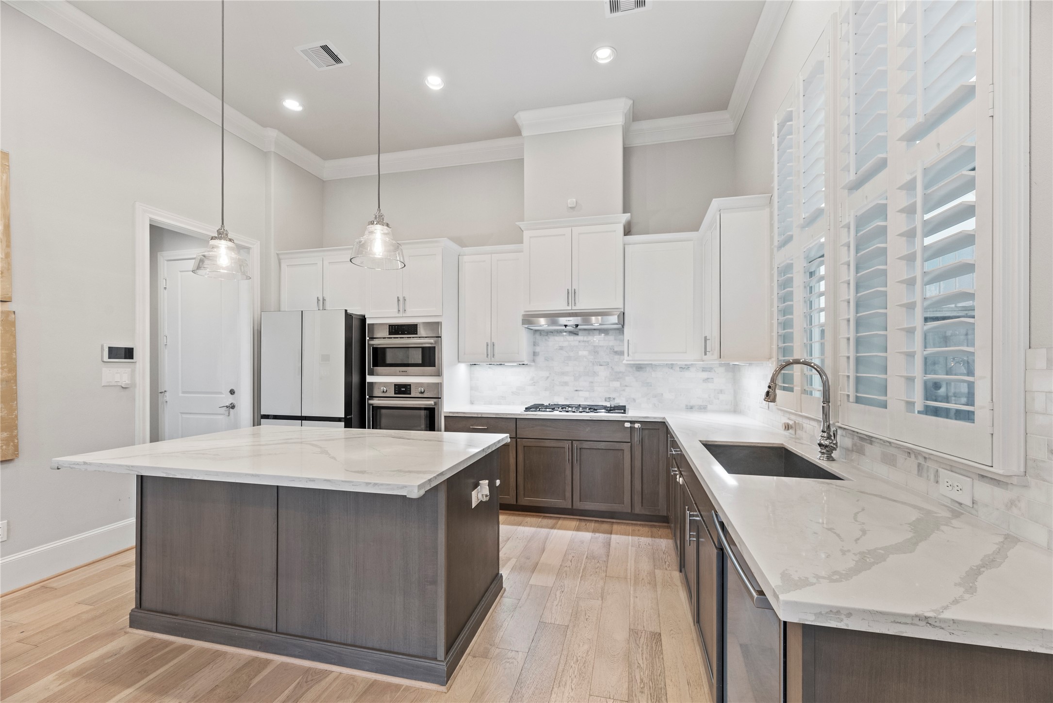 5306 South Capitol Street Houston, TX 77023 - Photo 7 of 28 a large kitchen with stainless steel appliances kitchen island granite countertop a sink a stove and a refrigerator