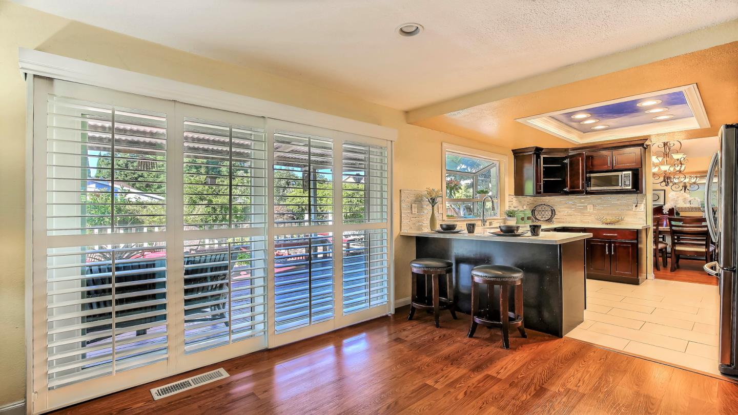 5709 Silver Leaf Road San Jose, CA 95138 - Photo 11 of 21 a view of kitchen with granite countertop a stove top oven a sink and dining table chair