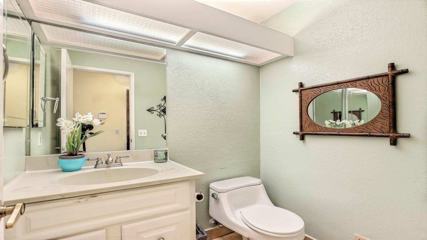 5709 Silver Leaf Road San Jose, CA 95138 - Photo 12 of 21 a bathroom with a toilet a sink and mirror