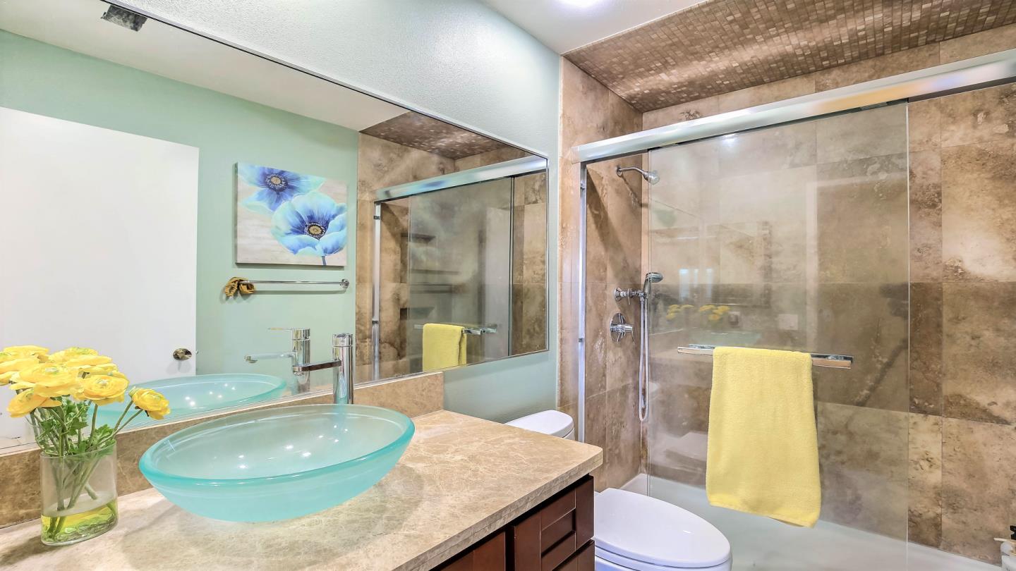 5709 Silver Leaf Road San Jose, CA 95138 - Photo 19 of 21 a bathroom with a granite countertop sink a toilet and tub