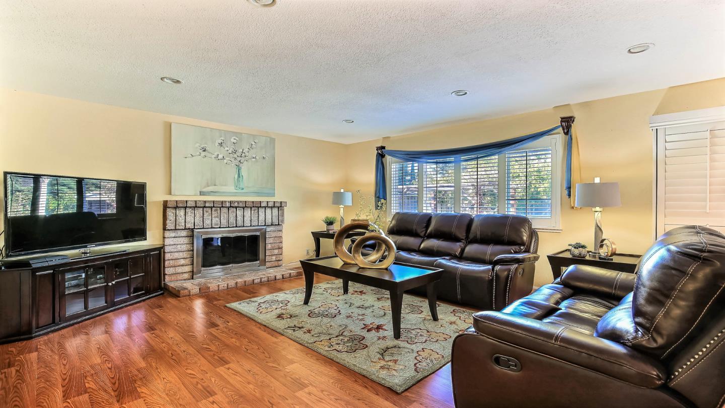 5709 Silver Leaf Road San Jose, CA 95138 - Photo 6 of 21 a living room with furniture a flat screen tv and a fireplace