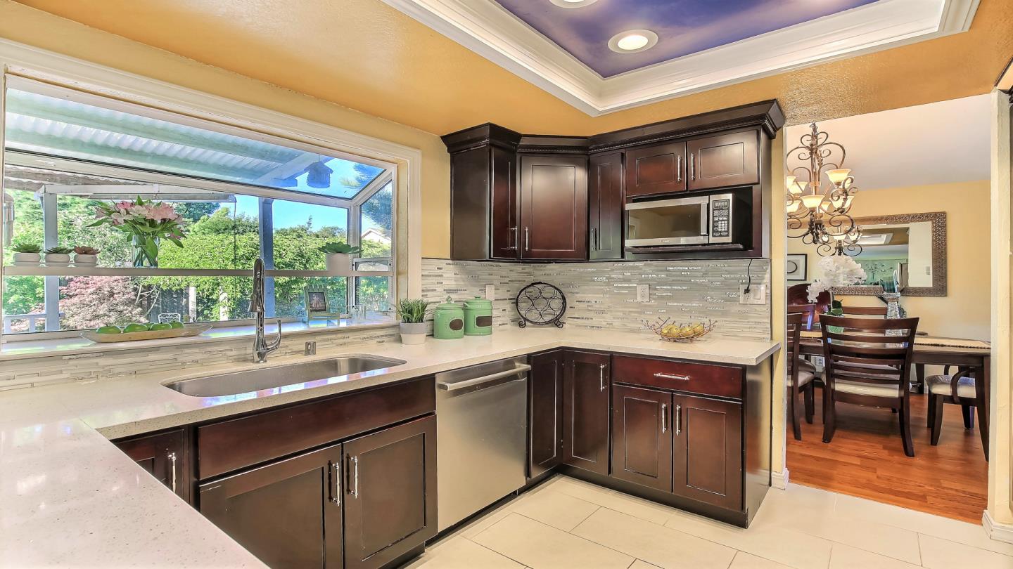 5709 Silver Leaf Road San Jose, CA 95138 - Photo 8 of 21 a kitchen with a sink stove and cabinets