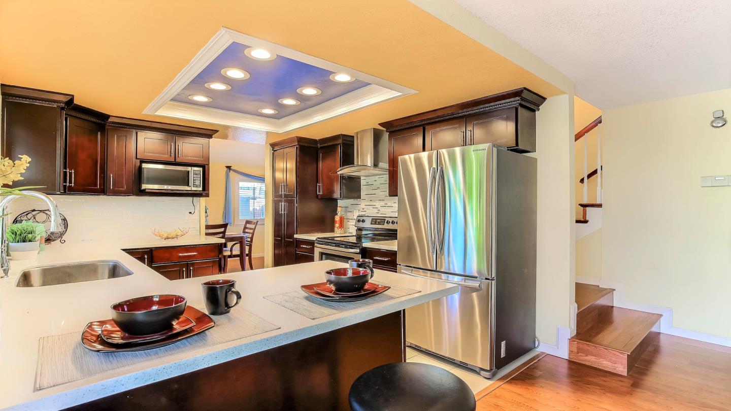 5709 Silver Leaf Road San Jose, CA 95138 - Photo 9 of 21 a kitchen with stainless steel appliances granite countertop a sink refrigerator stove and microwave