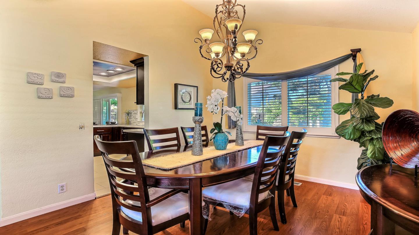 5709 Silver Leaf Road San Jose, CA 95138 - Photo 10 of 21 a view of a dining room with furniture wooden floor and chandelier