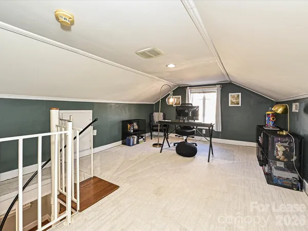 a view of a room with workspace and wooden floor