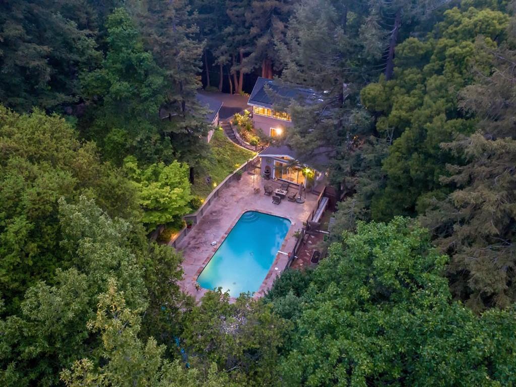 an aerial view of a house with a yard