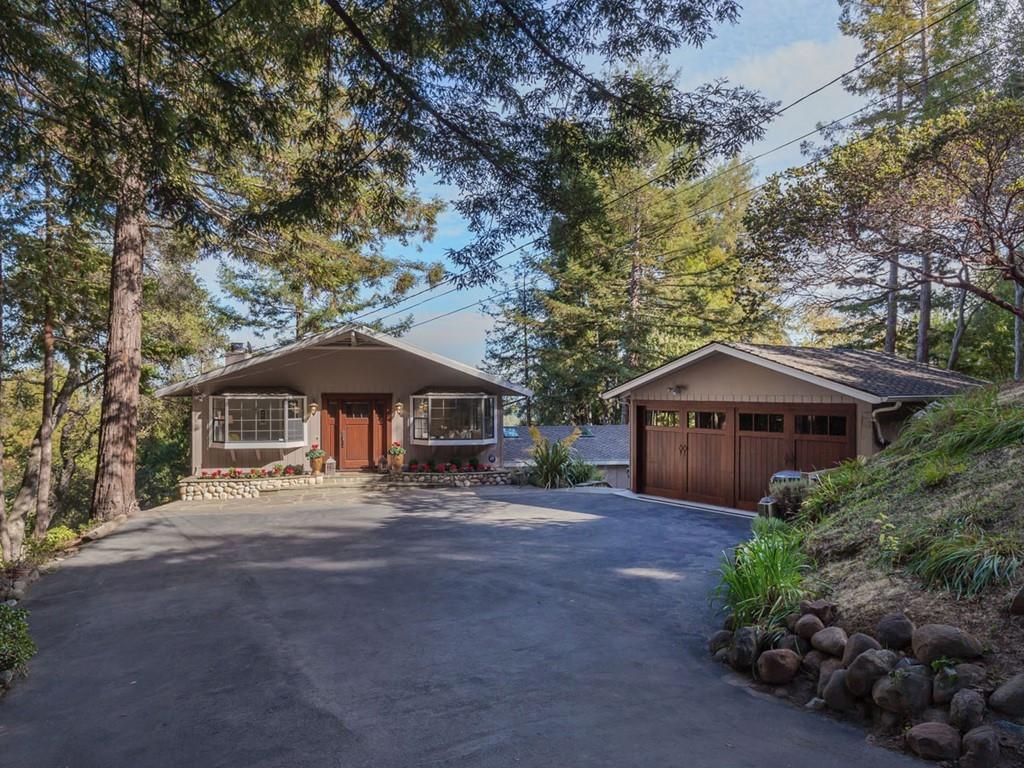 518 Patrol Road Woodside, CA 94062 - Photo 2 of 37 a view of a large house with a tree and plants