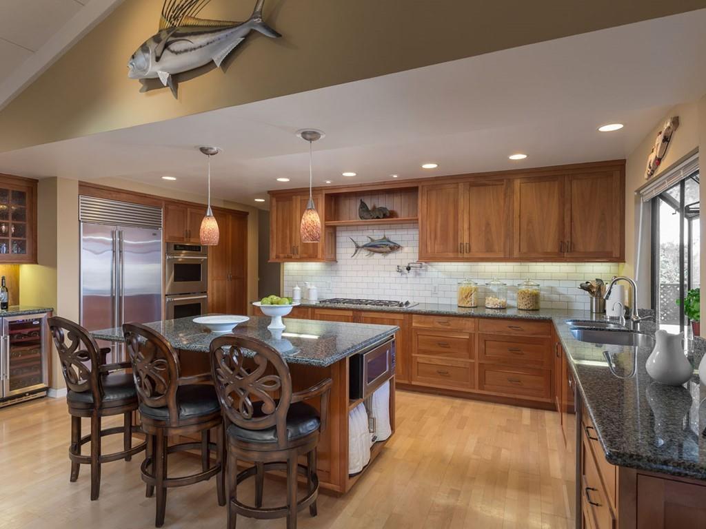 518 Patrol Road Woodside, CA 94062 - Photo 7 of 37 a kitchen with stainless steel appliances granite countertop a table chairs sink and cabinets