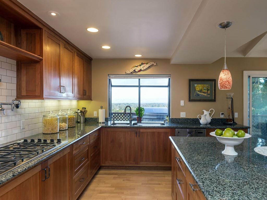 518 Patrol Road Woodside, CA 94062 - Photo 8 of 37 a kitchen with stainless steel appliances granite countertop a sink a stove and a wooden cabinets
