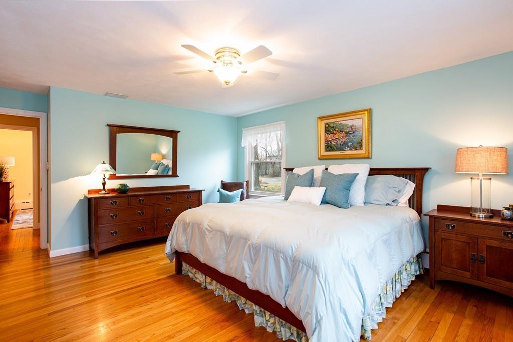 79 Wenonah Road Longmeadow, MA 01106 - Photo 15 of 29 a bedroom with a bed and a chandelier