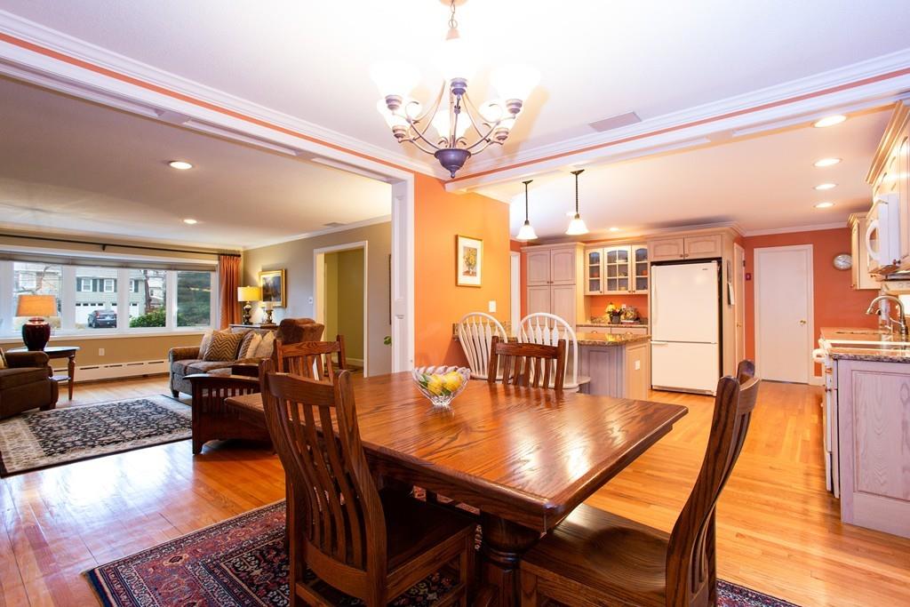 79 Wenonah Road Longmeadow, MA 01106 - Photo 7 of 29 a dining room with wooden floor a chandelier a wooden table and chairs