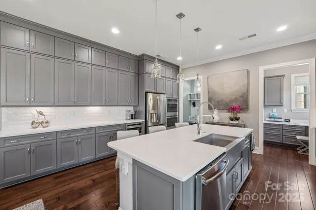 a kitchen with sink cabinets and refrigerator