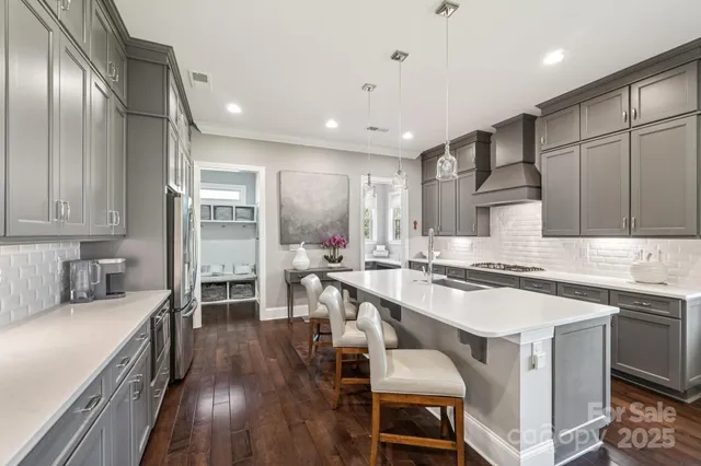 a kitchen with a table chairs stove and cabinets