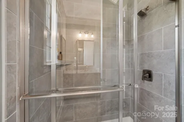a bathroom with a glass shower door