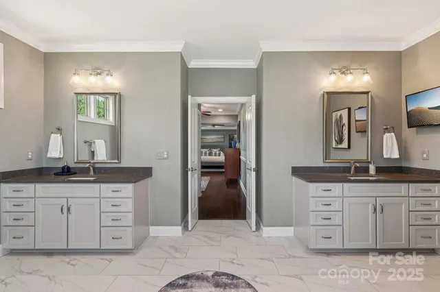 a spacious bathroom with a granite countertop sink and mirror