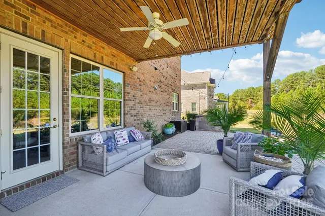 a building outdoor space with patio furniture and potted plants