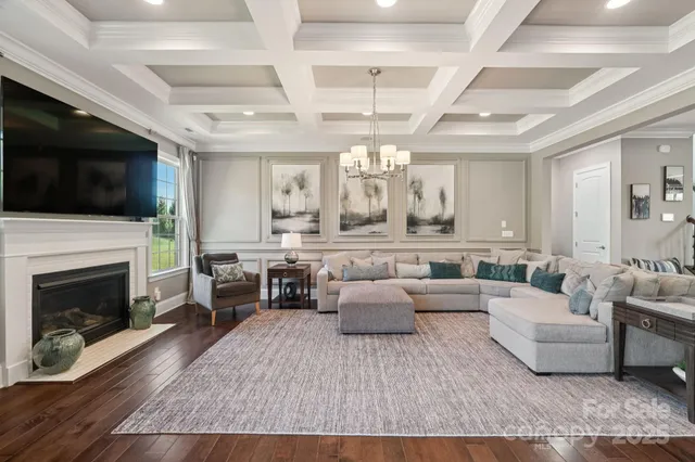 a living room with furniture fireplace and flat screen tv