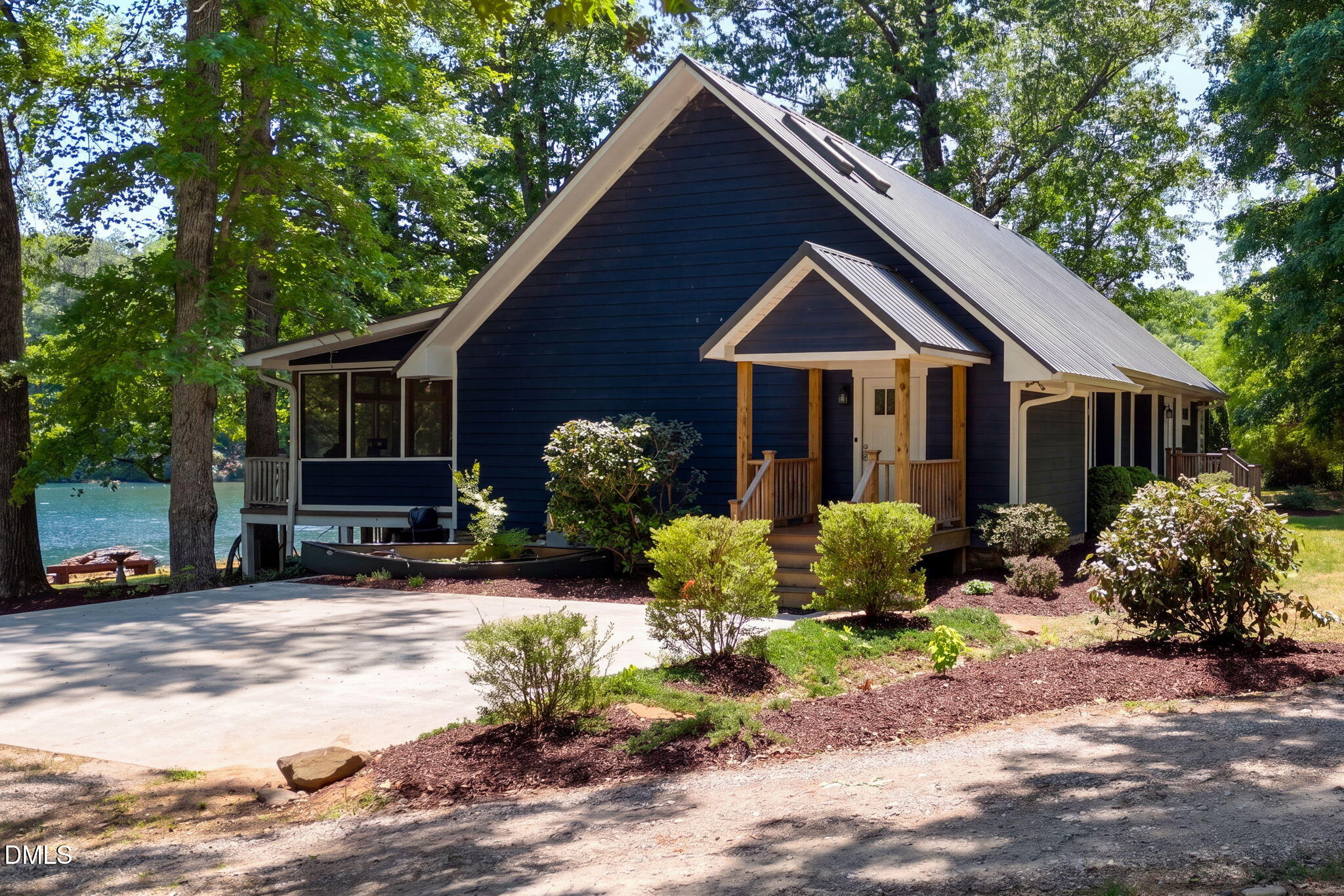 370 Robinson Ferry Road Macon, NC 27551 - Photo 64 of 85 a front view of a house with a yard and potted plants