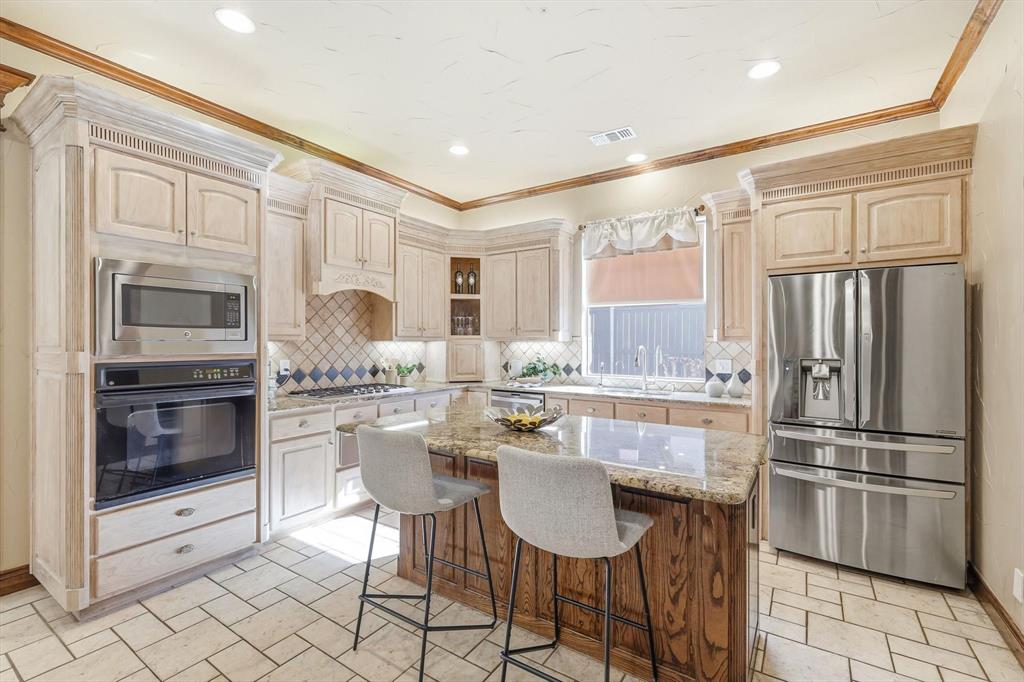 727 Madison Street Coppell, TX 75019 - Photo 11 of 36 a kitchen with stainless steel appliances a refrigerator sink and microwave