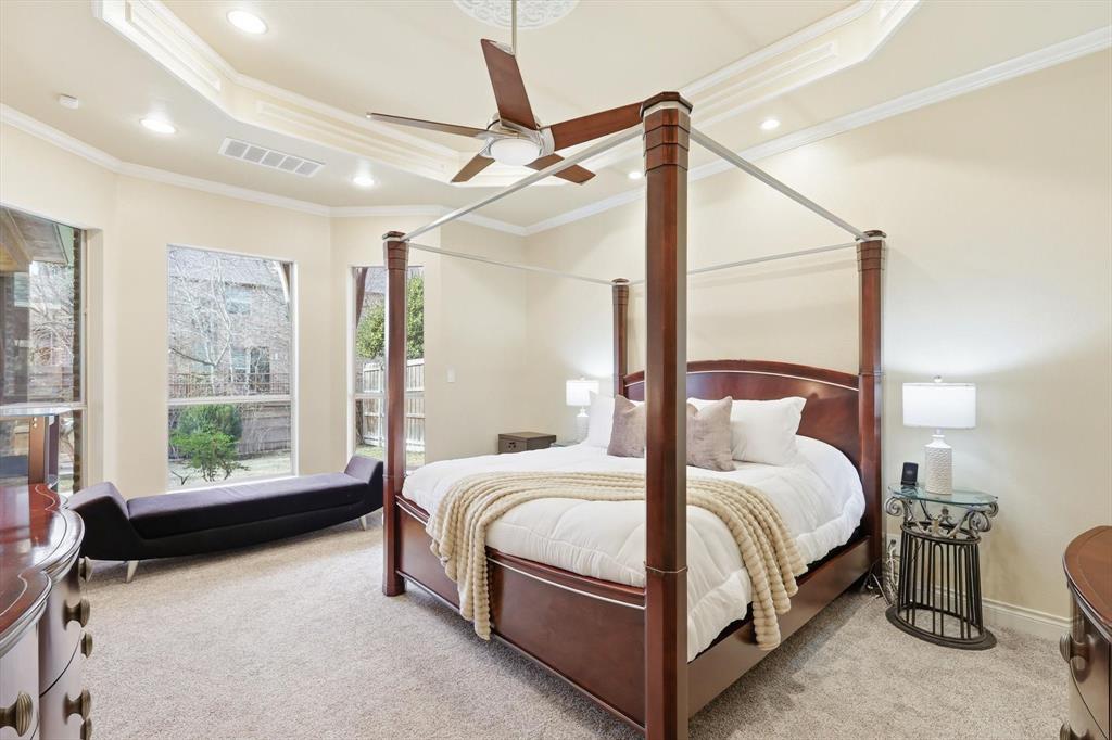 727 Madison Street Coppell, TX 75019 - Photo 18 of 36 a bedroom with a bed lamp and a large window