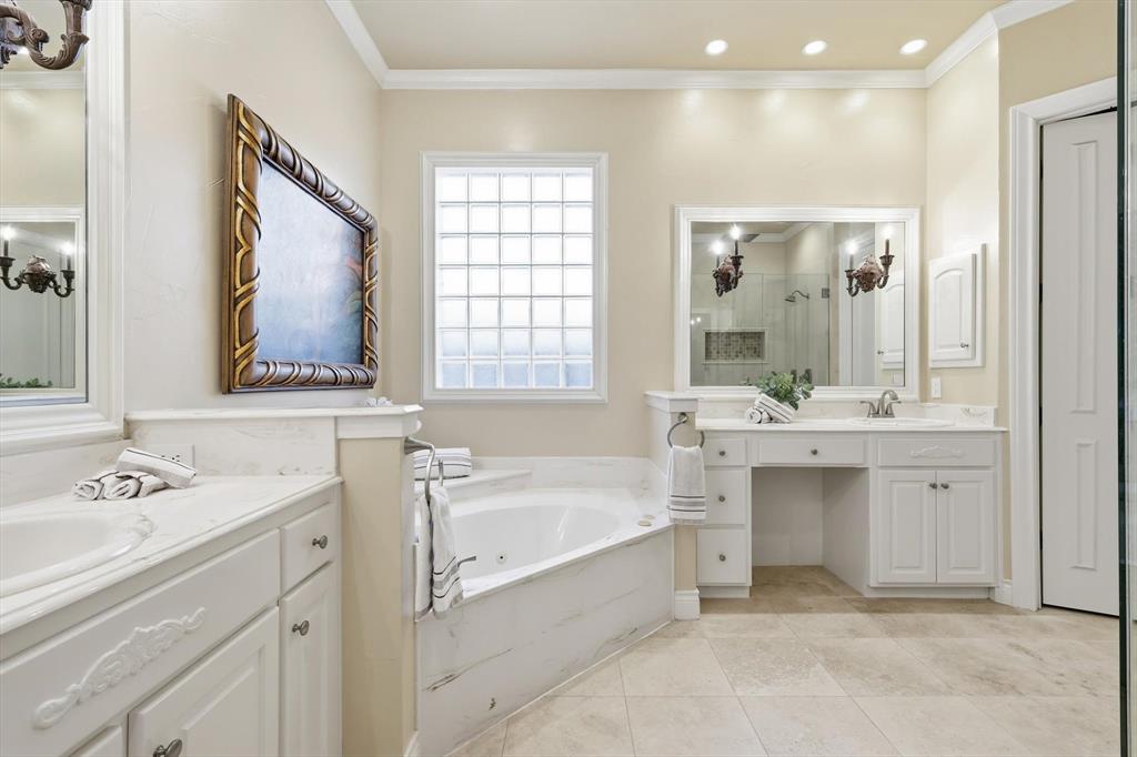 727 Madison Street Coppell, TX 75019 - Photo 19 of 36 a bathroom with a tub sink and mirror