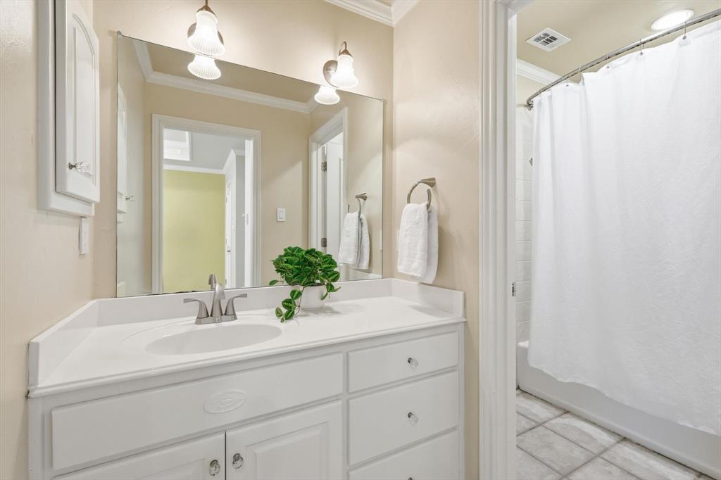 727 Madison Street Coppell, TX 75019 - Photo 25 of 36 a bathroom with a sink a mirror and a shower