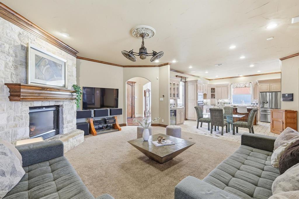 727 Madison Street Coppell, TX 75019 - Photo 7 of 36 a living room with furniture a fireplace and a flat screen tv