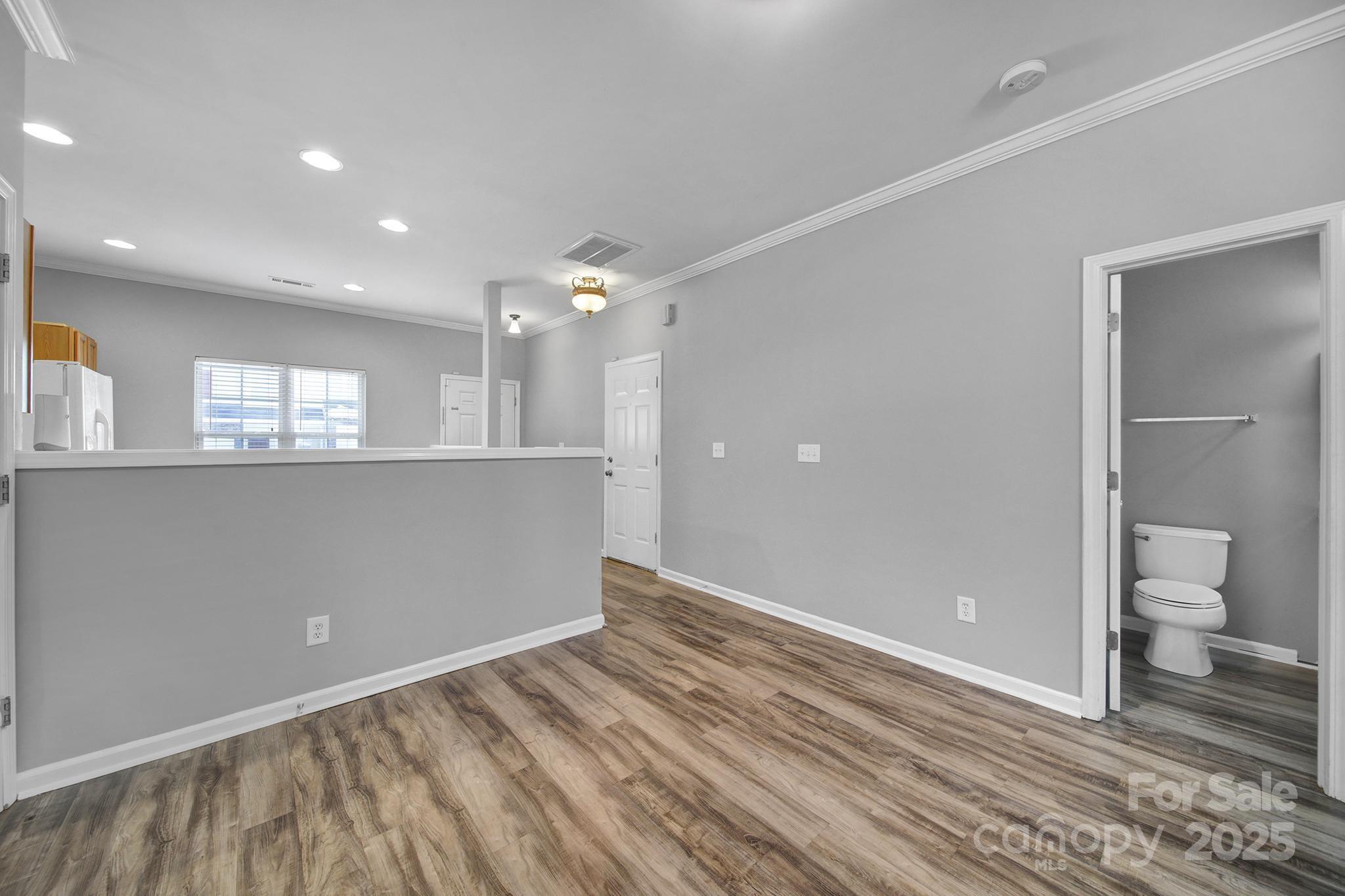 13719 Singleleaf Lane Charlotte, NC 28278 - Photo 11 of 42 a view of a big room with wooden floor and windows