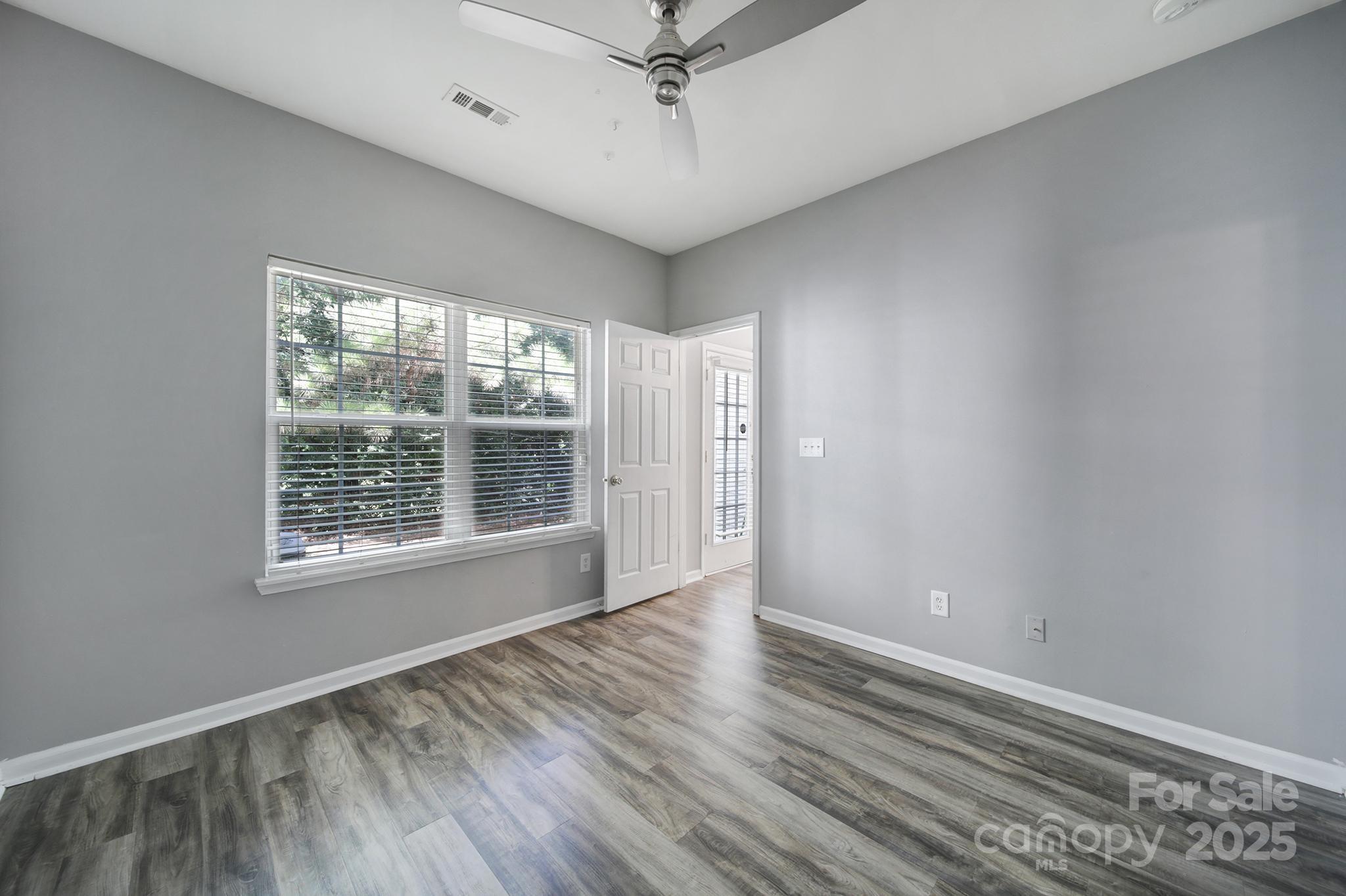 13719 Singleleaf Lane Charlotte, NC 28278 - Photo 18 of 42 a view of an empty room with a window and wooden floor