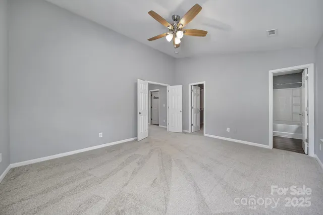 a view of an empty room with a fan