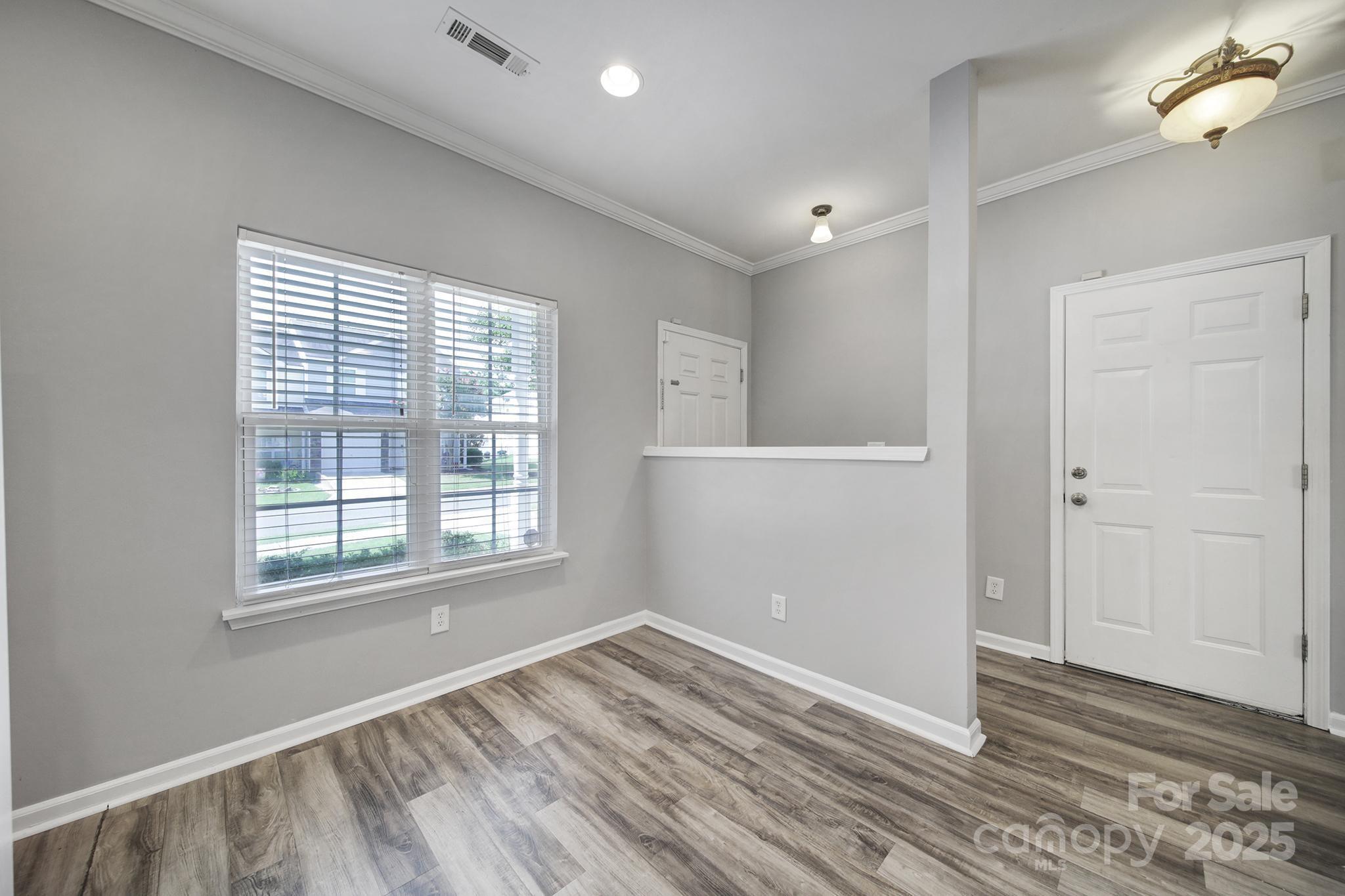 13719 Singleleaf Lane Charlotte, NC 28278 - Photo 3 of 42 a view of empty room with wooden floor and fan