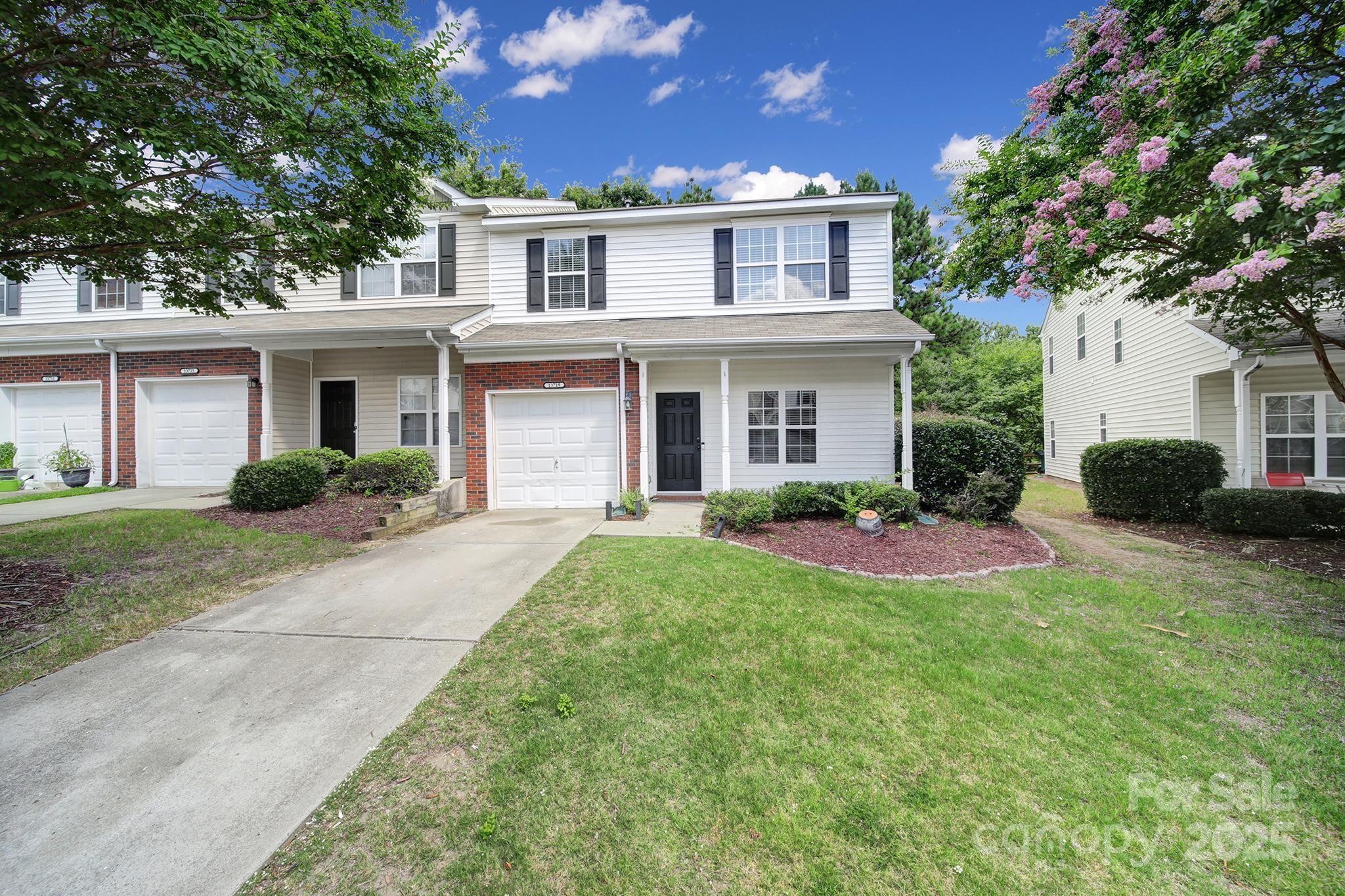 13719 Singleleaf Lane Charlotte, NC 28278 - Photo 40 of 42 a front view of a house with a yard and potted plants