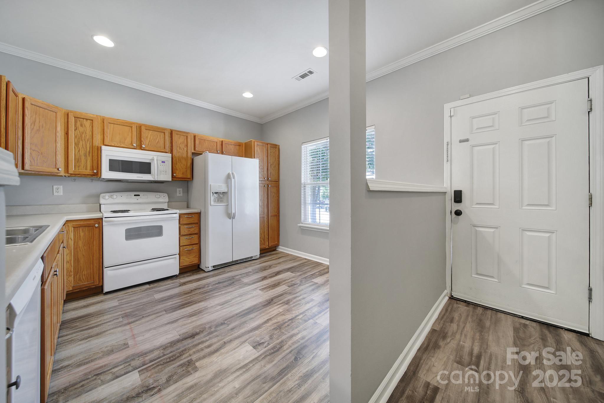 13719 Singleleaf Lane Charlotte, NC 28278 - Photo 4 of 42 a kitchen with a white stove top oven and refrigerator