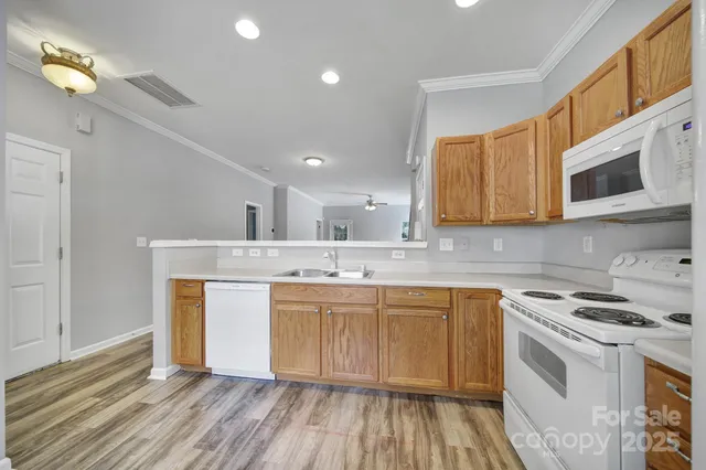 a kitchen with stainless steel appliances granite countertop a sink and cabinets